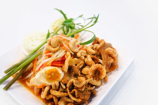 Papaya salad (somtum) with salted eggs and fried pork rind.