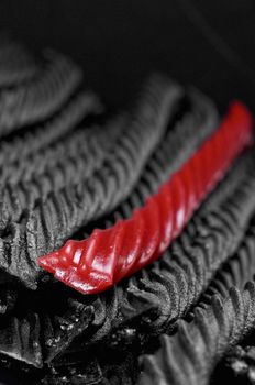 single red licorice in black