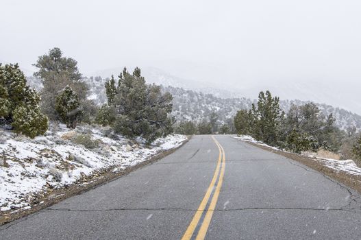 Snow falling on Death Valley National Park, California road in winter