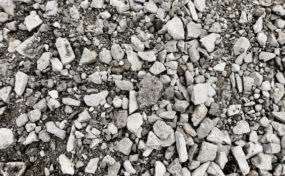 Top down view on a grey gravel stones texture. Background shot.