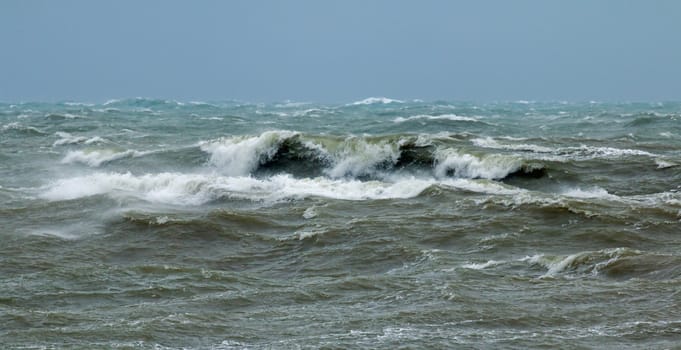 Rough sea in English Channel off Seaford in East Sussex with waves breaking and spindrift.