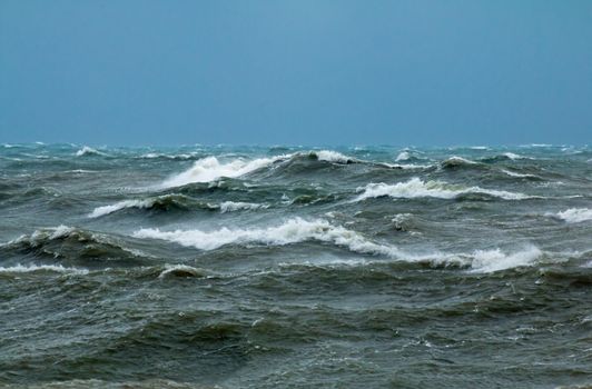 Rough seas with crashing waves in English Channel off Seaford in East Sussex.