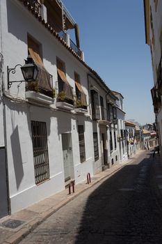 Empty narrow streets with buildings on either side to offer shade on a sunny day