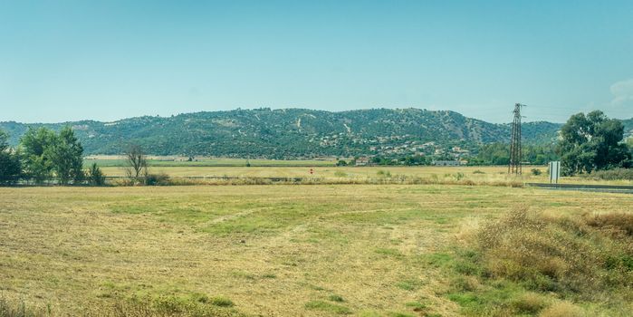 Mountains and grass on the spanish countryside of Cordoba, Spain,Europe, Anadalucia on a bright sunny day with blue sky