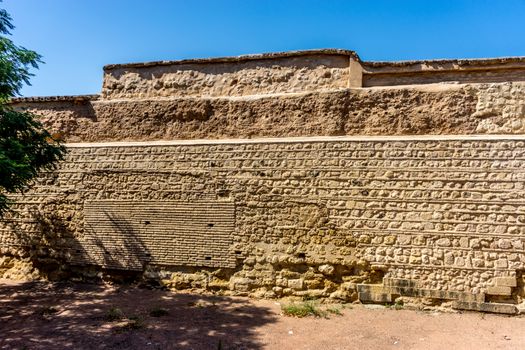 Photo of an ancient ruin wall in Cordoba, Spain, Europe on a summer day with blue sky