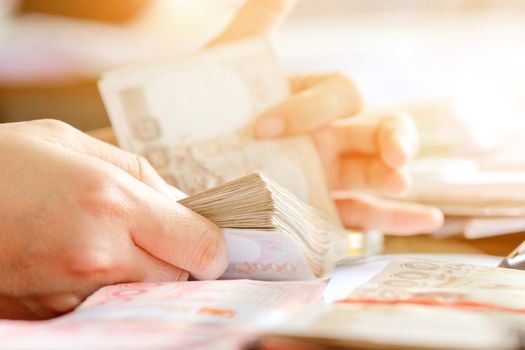 close up image of female hand count the money, business accounting background