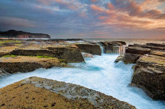 Sunrise skies from the eroded rocky channel at North Narrabeen near Sydney, Australia