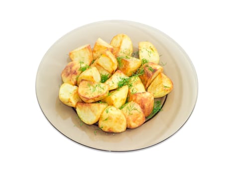 Serving of the country style fried potatoes sprinkled by chopped dill on the dark glass dish on a light background
