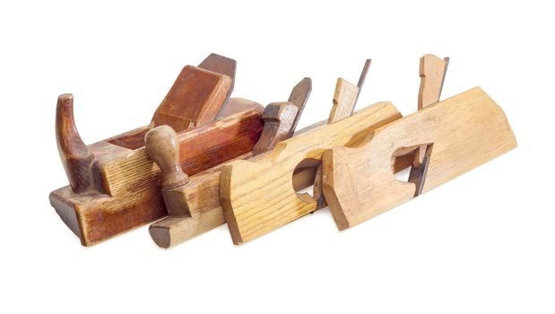 Several old wooden hand planes different special purposes on a white background
