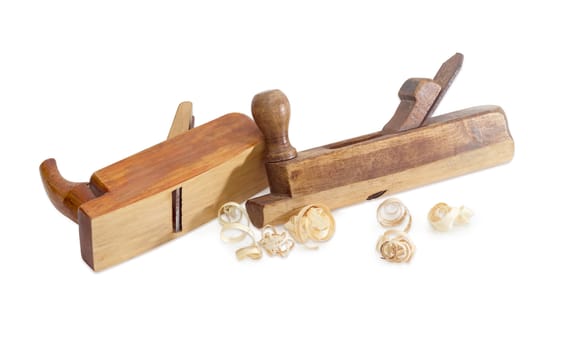 Two old wooden hand planes different special purposes and shavings on a white background
