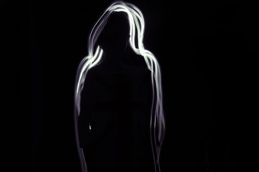 A silhouette of a girl on a black background. Glow white-purple line is around her.
