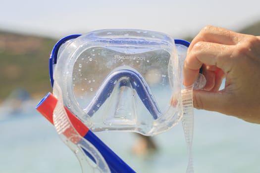 Blue Snorkel glasses in the hand