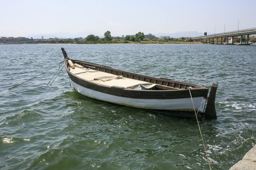 Little wooden boat in a river side