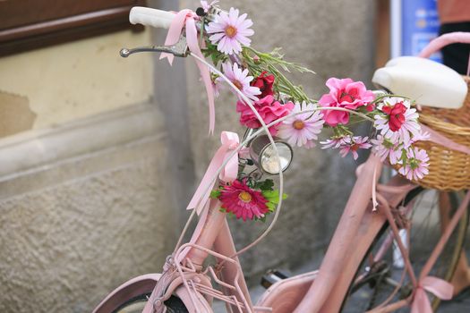 vintage Pink bicycle with basket of flowers