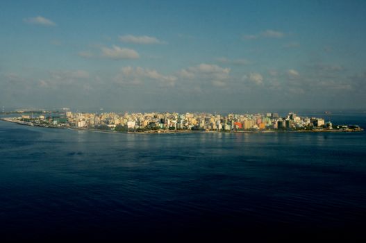 Aerial View of Male Maldivian Capital on Blue Sky with Clouds Early Morning Outdoors