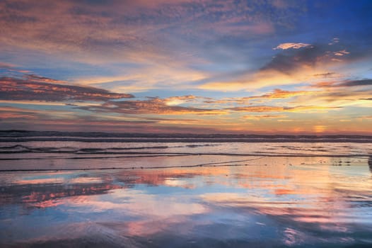 Beautiful clouds in blue sky with reflection in calm water in the morning lake. Nature wallpaper