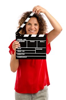 Portrait of a smiling middle aged brunette holding a clapboard