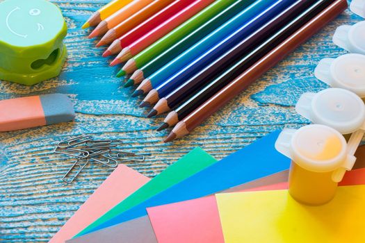 School supplies on a blue background, paints and brushes