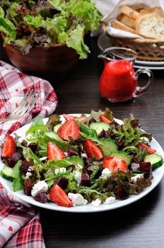 Salad of vinaigrette with strawberries, tender feta and strawberry sauce
