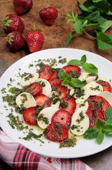 Light snack caprese with strawberries and mozzarella dressed   mint pesto