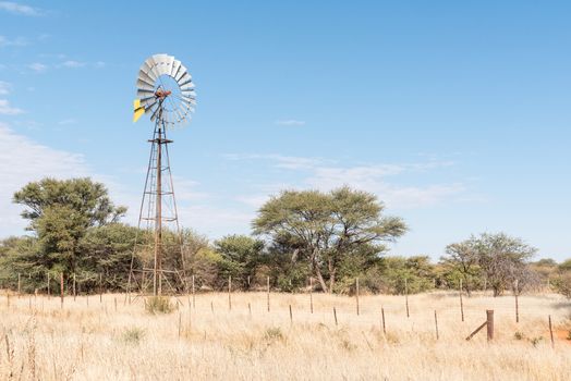 A farm scene with water-pumping windmill on the B1-road between Okahandja and Otjiwarongo in the Otjozondjupa Region of Namibia