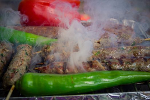 Different types of meat are cooked on the grill - close up