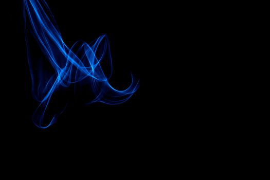 Light painted glowing abstract blue curved lines on a black background