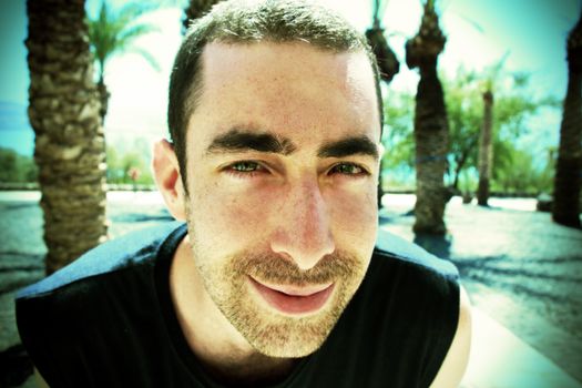 Young man smiling and looking at camera.