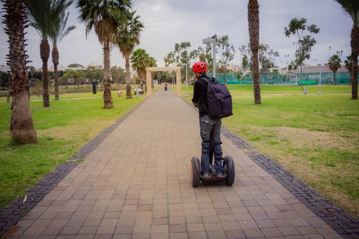 Man riding on a Segway in the park.