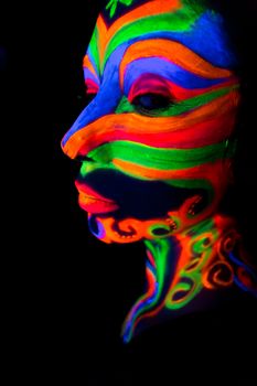 Woman with make up art of glowing UV fluorescent powder.