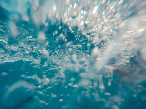 Underwater view of bubbles in motion.