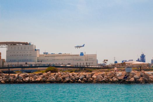 Light aircraft landing above the sea. Mediterranean coast, Tel Aviv, Israel.