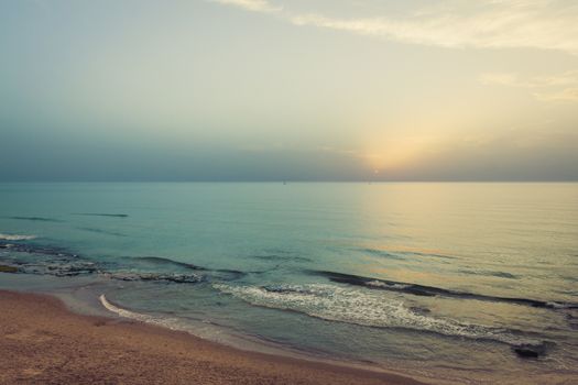 Sunset over the sea. Silhouette of boats on the horizon.