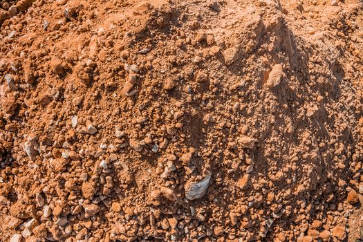 Pile of sand and stones at a construction site.