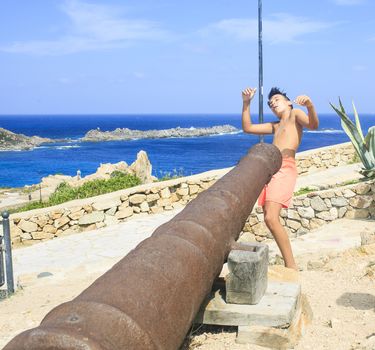 young boy playing with a cannon
