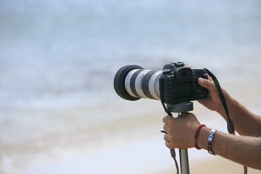 Photographer making a photo on the sea