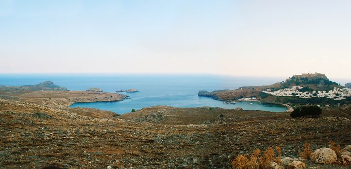 Panoramic view of the bay of the White City of Lindos, Rhodes Island, during sunset.
