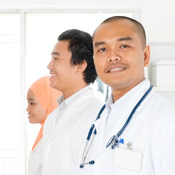 Clinic, profession, people, health care and medicine concept - happy group of Southeast Asian medics or doctors at hospital.