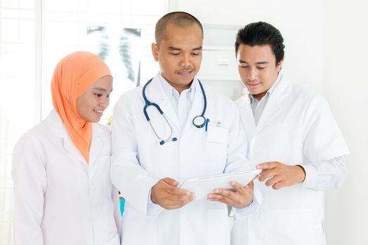 Medical team discussion diagnose disease concept. Southeast Asian Muslim doctors.