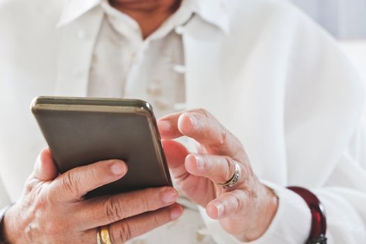 close up image of Senior woman using her mobile phone background.  An idea of modern lifestyle, communication,telecommunication,connectivity, social networking