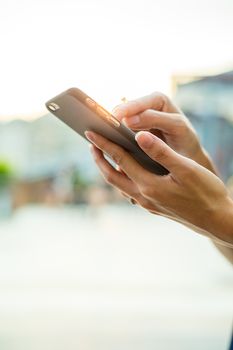 Woman sending sms on cellphone