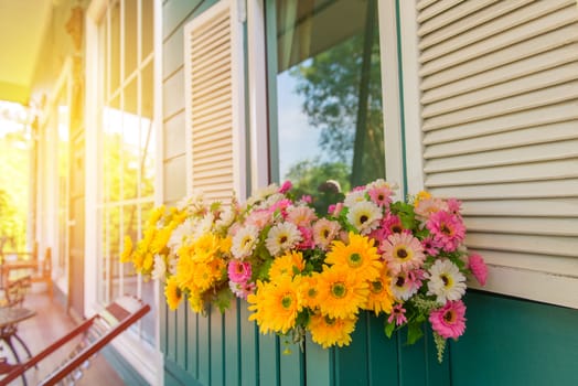 window with flower box and shutters at home.
