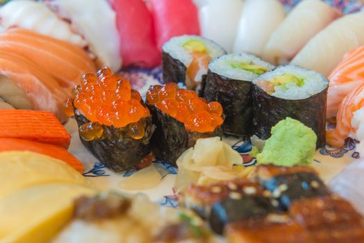 Salmon raw sashimi sushi with shrimp on plate, japanese food.