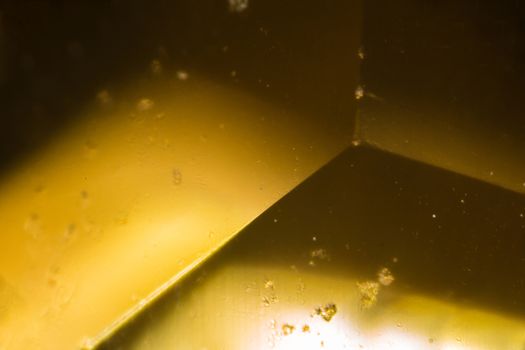 Yellow gem under the microscope. Closeup macro photography.