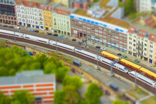 Aerial view of Berlin skyline with S-Bahn tracks rapid train and colorful buildings. with tilt-shift effect.