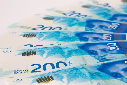 Stack of Israeli money bills of 200 shekel.