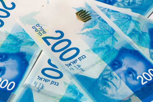 Stack of Israeli money bills of 200 shekel.