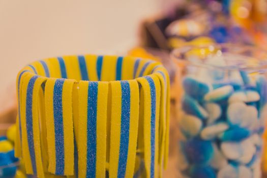 Close up of bowl with colorful sweet tasty gummy candy at children birthday party.