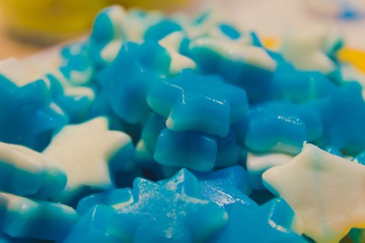 Close up of bowl with colorful sweet tasty gummy candy at children birthday party.