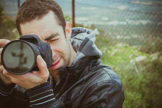 Photographer shooting outside with digital camera.